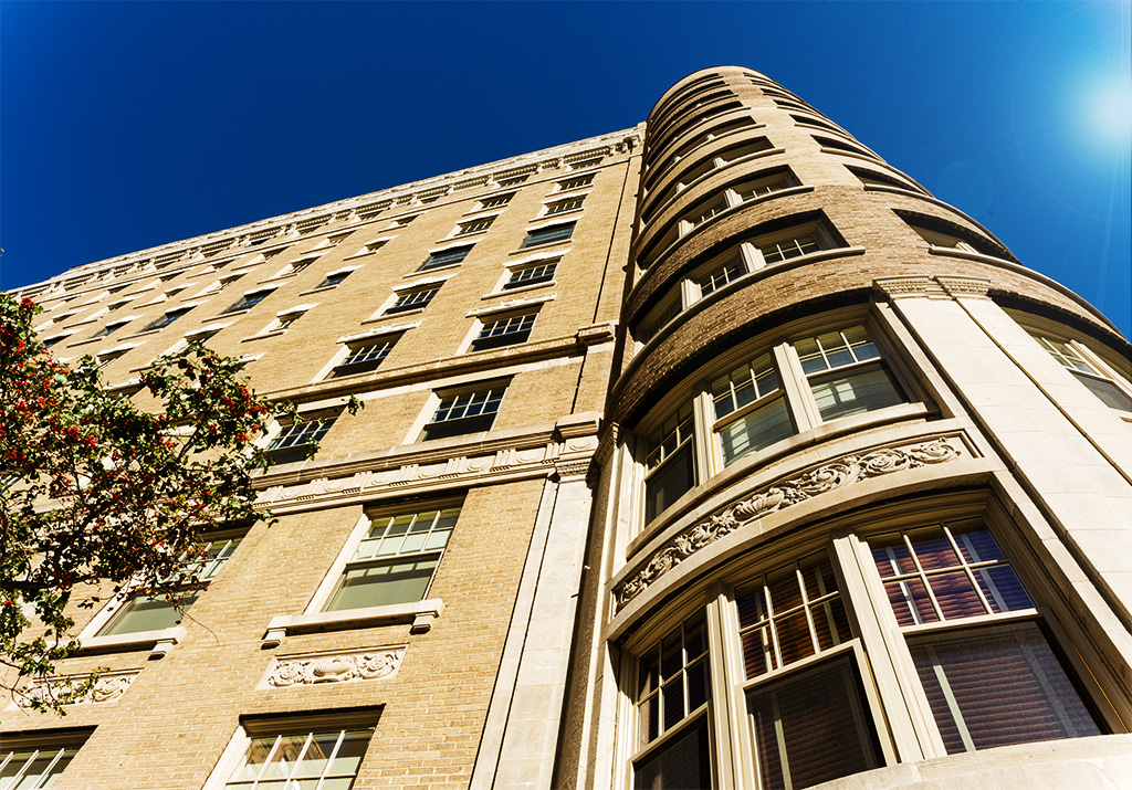 Dramatic upward view of large condo building
