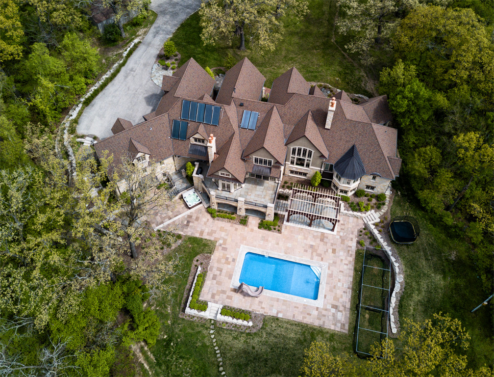birds eye view of home, landscaping and pool 