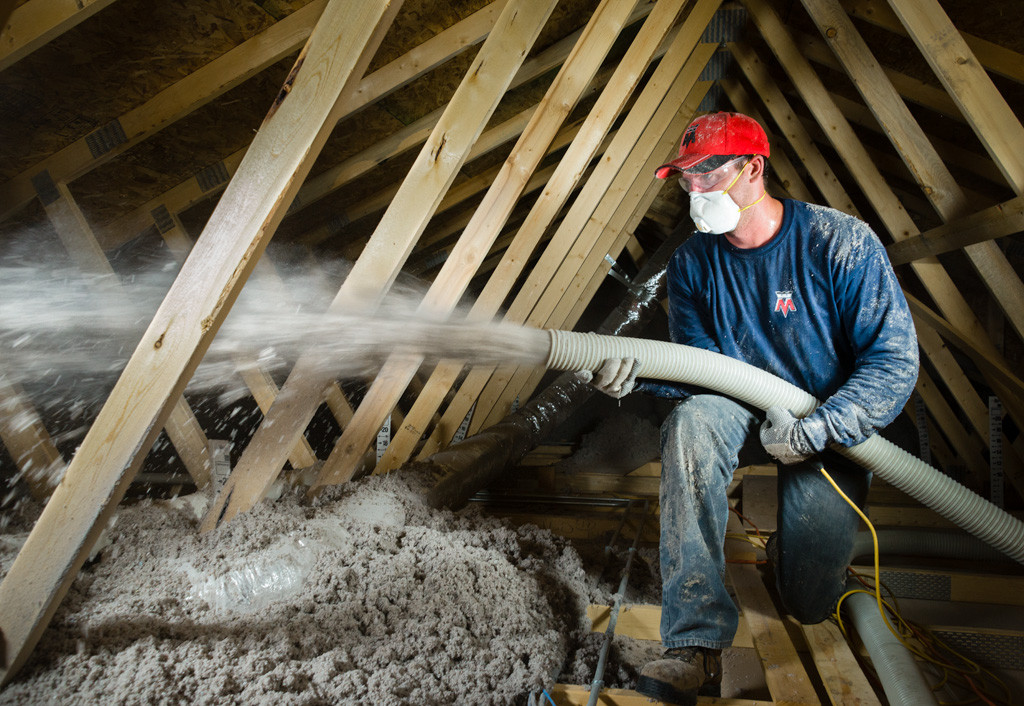 Attic insulation being blown